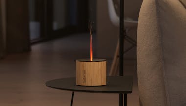 Nora aroma diffuser from Stadler Form on a side table next to a couch