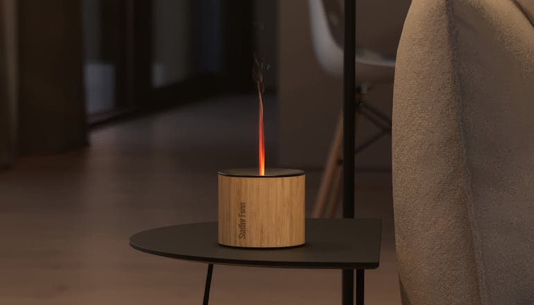 Nora aroma diffuser from Stadler Form on a side table next to a couch