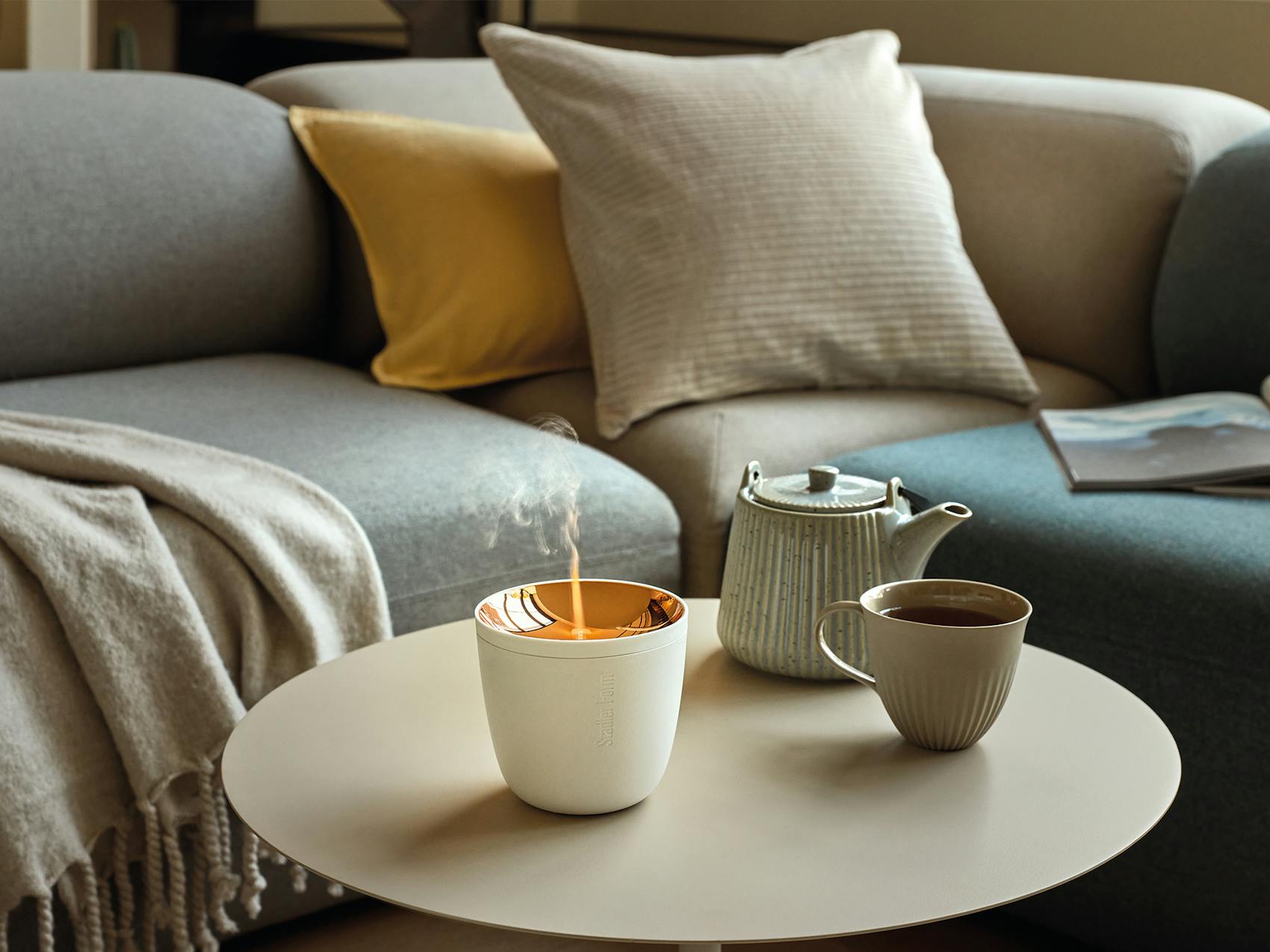 Zoe mobile aroma diffuser in white on a coffee table