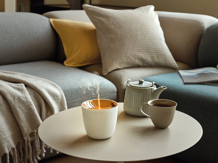 Zoe mobile aroma diffuser in white on a coffee table