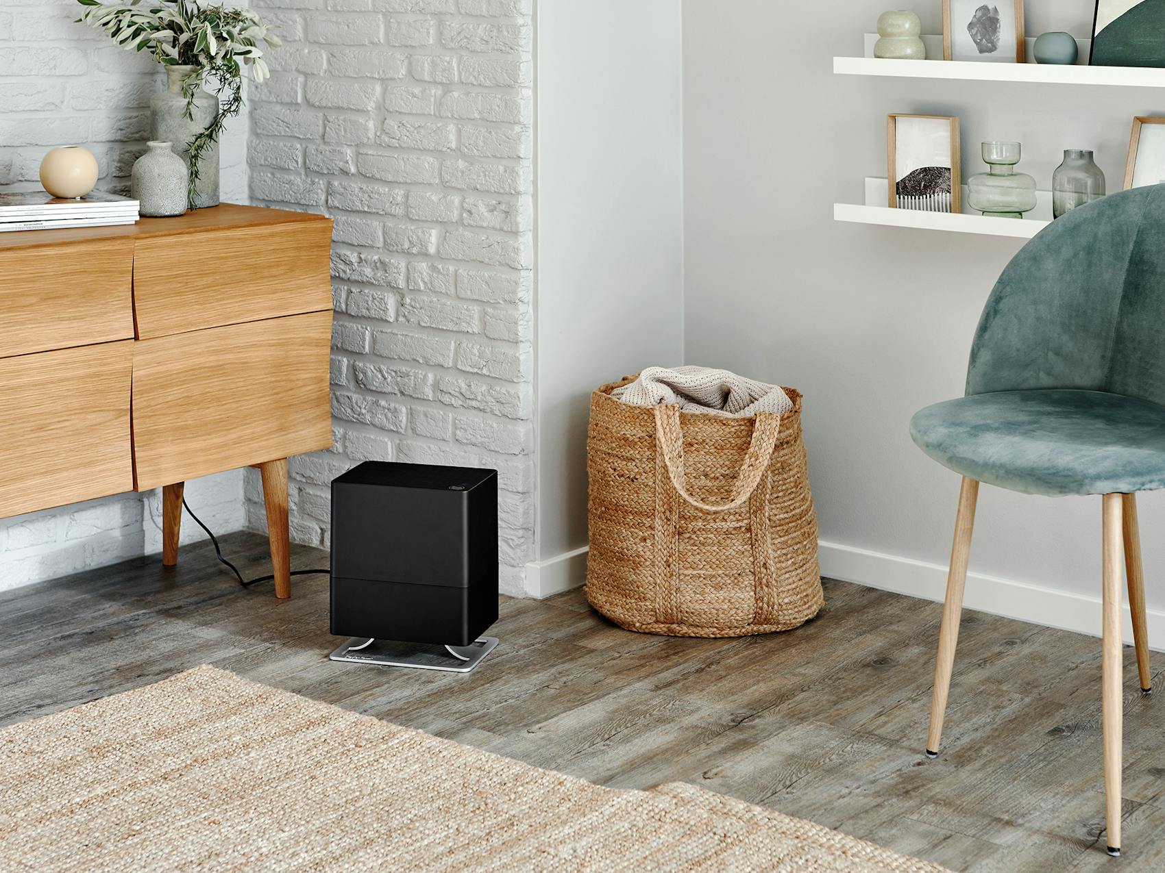 Oskar little humidifier by Stadler Form in black Oskar little humidifier by Stadler Form in black in a bright room next to chair and sideboard