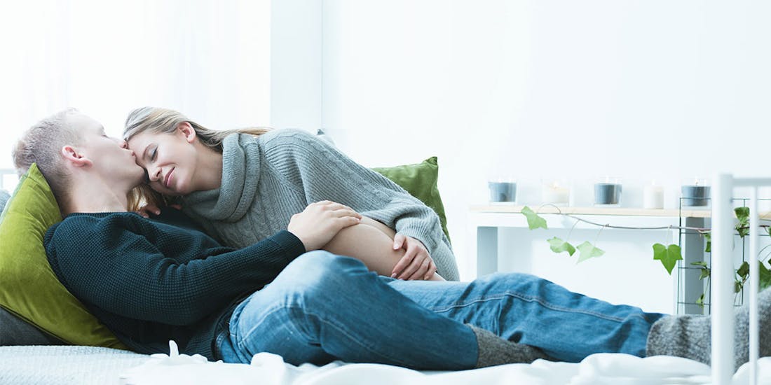 A couple cuddles on the couch A couple cuddles on the couch