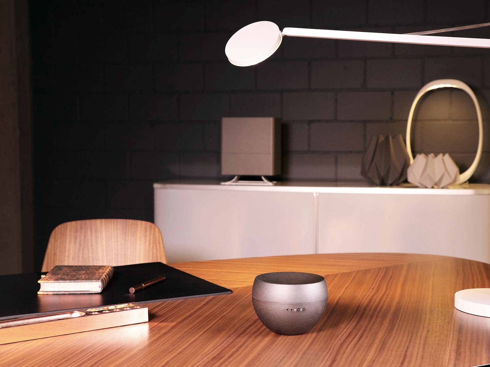 Jasmin aroma diffuser by Stadler Form in titanium on a table