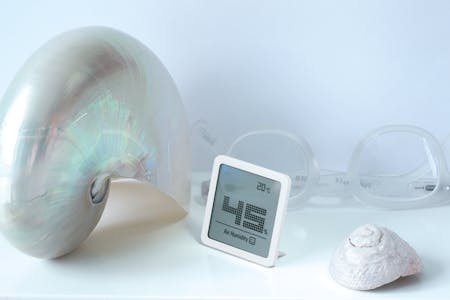 Selina little hygrometer by Stadler Form in white on a sidebaoard next to glasses and shells