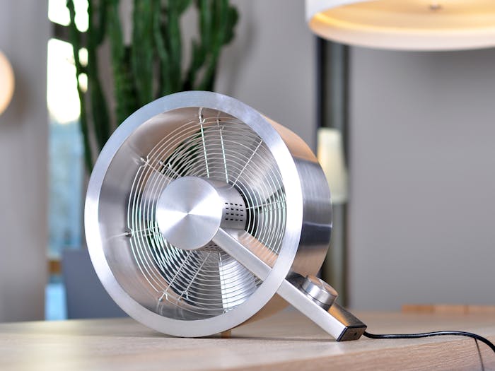 Q design fan by Stadler Form on a table