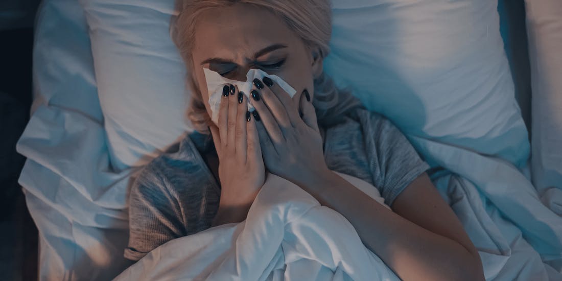 Woman with allergy sick in bed