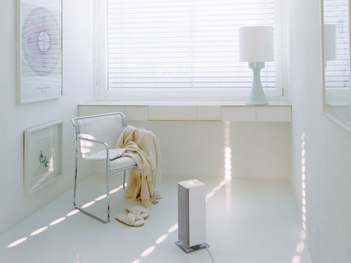 Anna big heater by Stadler Form in white next to a chair