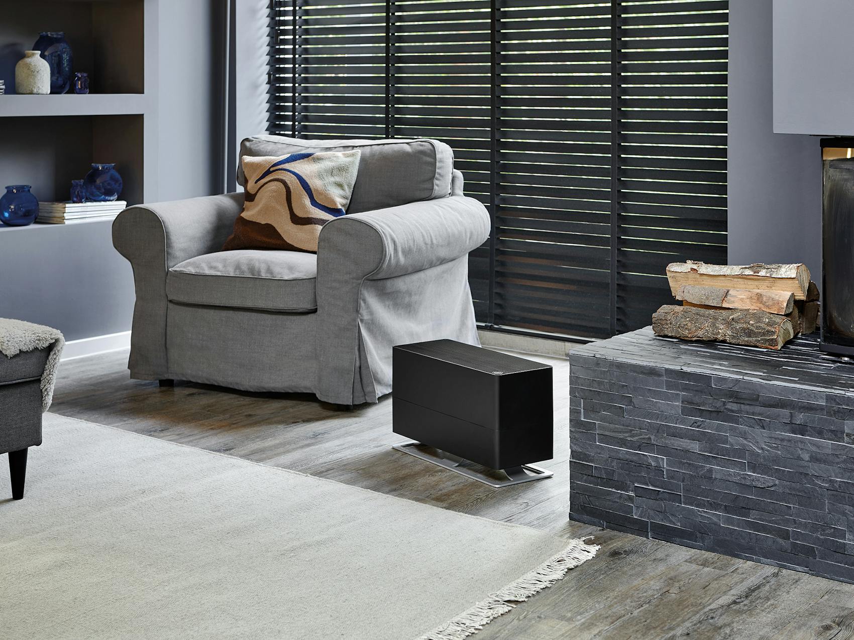 Oskar big humidifier by Stadler Form in black Oskar big humidifier by Stadler Form in black in living room with a fireplace
