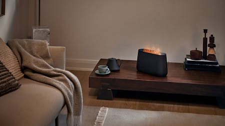 Ben humidifier with fireplace effect by Stadler Form in black in a living room