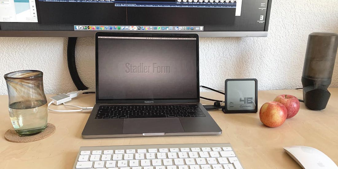 Selina hygrometer by Stadler Form in black next to a laptop