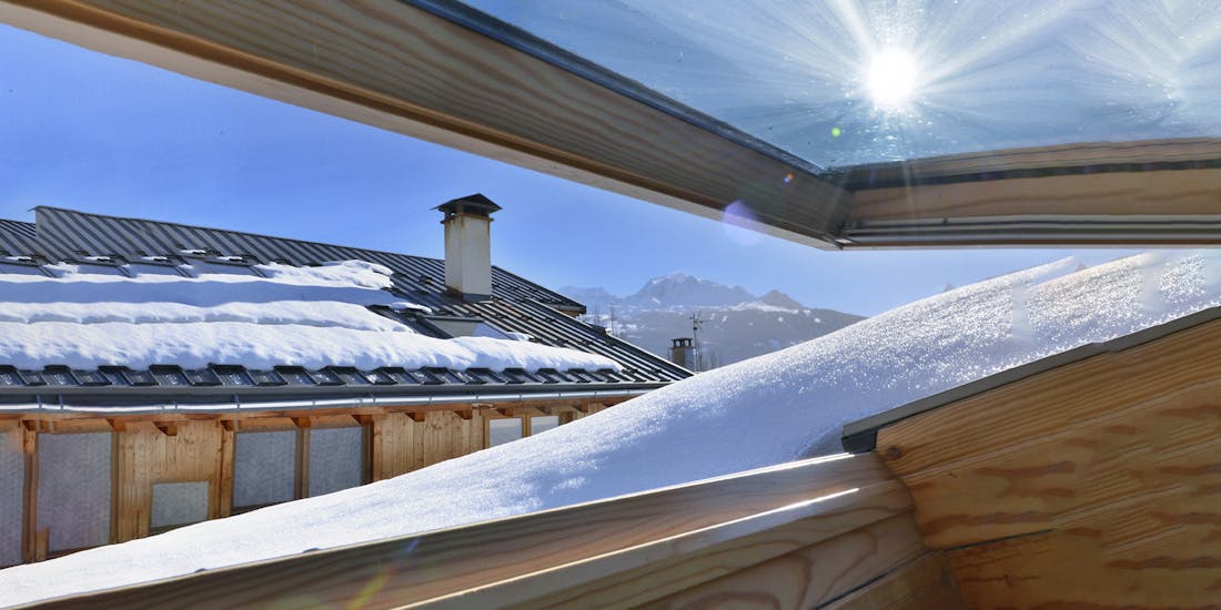 Open roof window in winter with snow