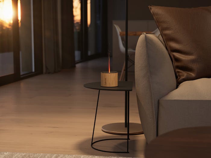 Nora aroma diffuser from Stadler Form on a side table next to a couch