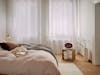 Erik fan heater with flame effect by Stadler Form in a bright bedroom