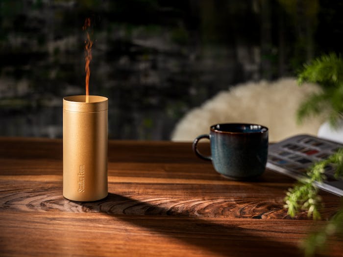 Lucy aroma diffuser by Stadler Form in gold on a table