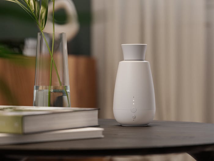 Aroma diffuser Ella by Stadler Form in a warm living room area on a table close up image