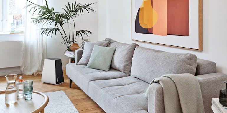 George air washer by Stadler Form next to a sofa in a living room George air washer by Stadler Form next to a sofa in a living room