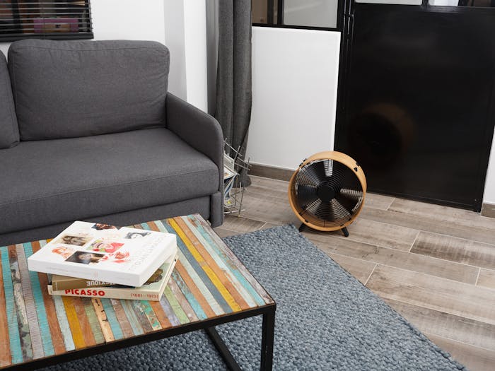 Otto bamboo fan by Stadler Form in a living room