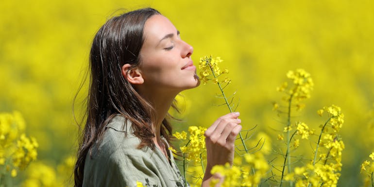 Woman smells flowers