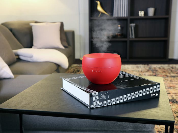 Jasmin aroma diffuser by Stadler Form in chili red on a side table