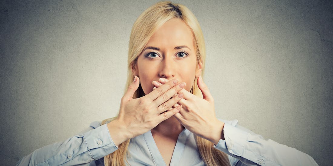 Woman covers her mouth with her hands Woman covers her mouth with her hands