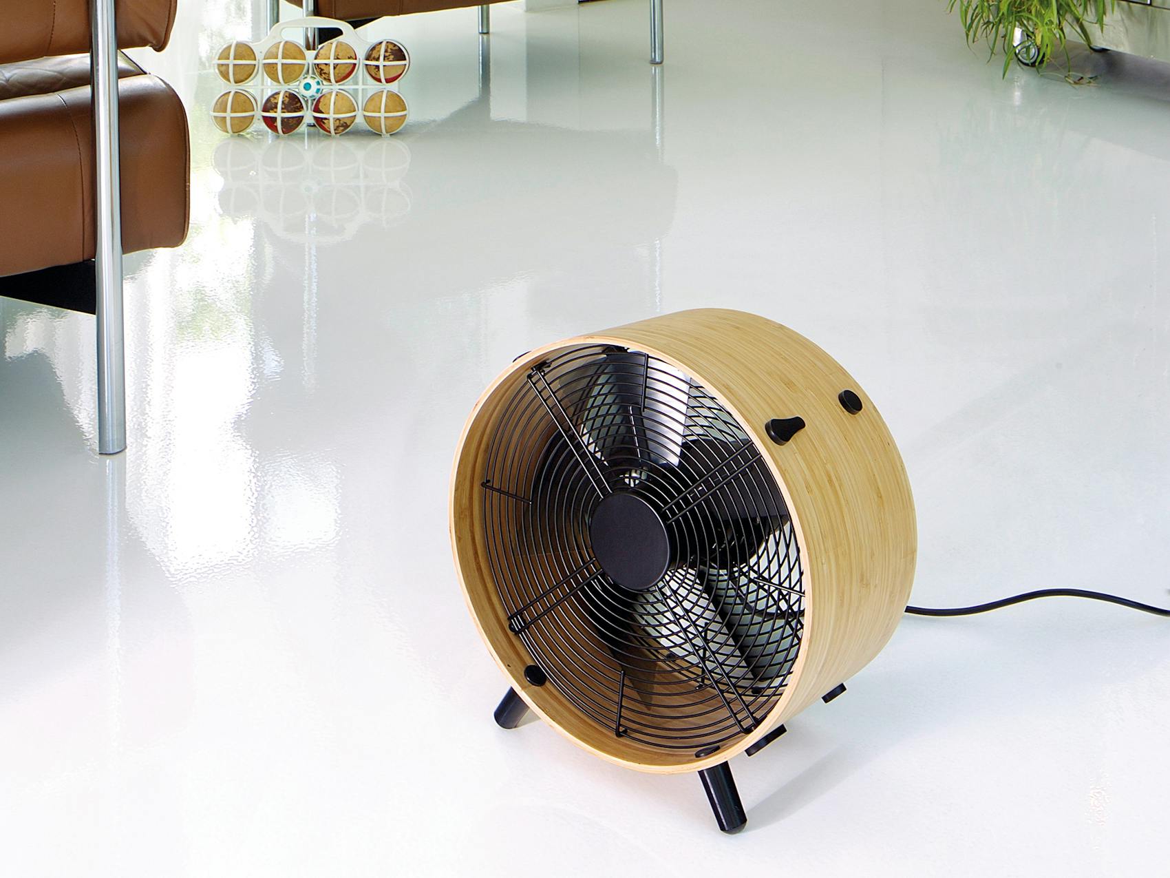 Otto bamboo fan by Stadler Form on the floor in a room