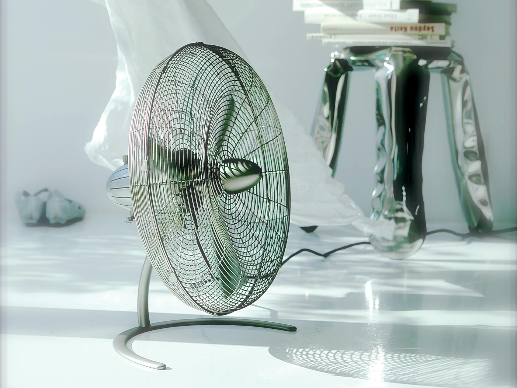 Charly floor fan by Stadler Form next to a curtain