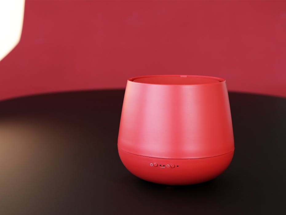 Julia aroma diffuser by Stadler Form in chili red Julia aroma diffuser by Stadler Form in chili red on a wood table
