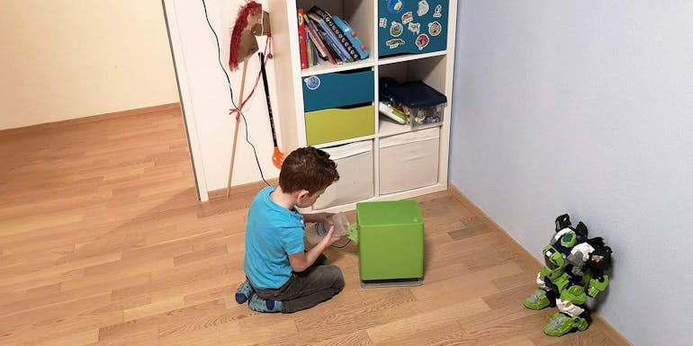 Ein Junge spielt neben einem kleinen Oskar-Luftbefeuchter von Stadler Form. Ein Junge spielt neben einem kleinen Oskar-Luftbefeuchter von Stadler Form.