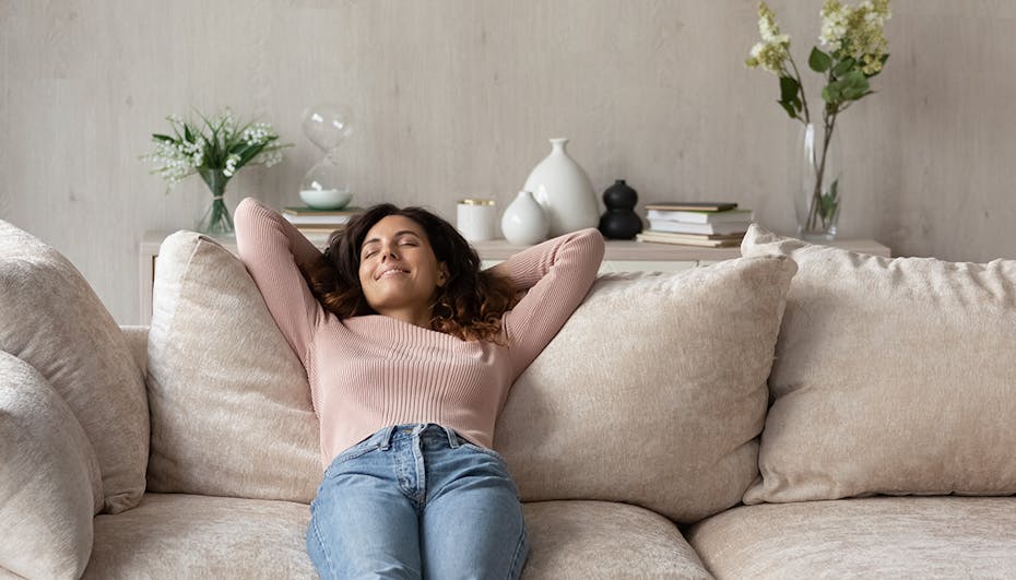 Woman is relaxed and happy on the sofa