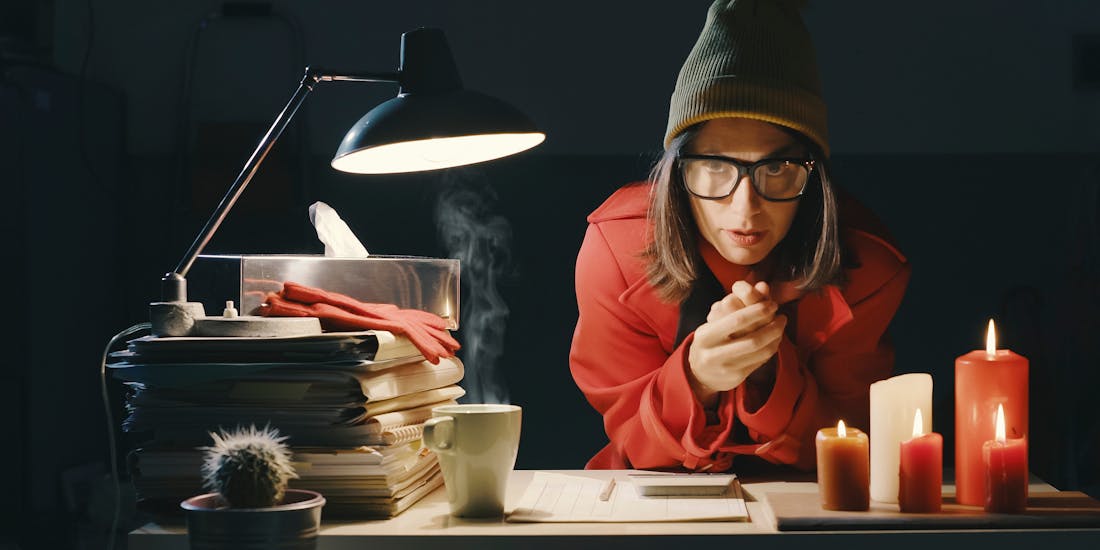 Symbolic image of a woman freezing at the office Symbolic image of a woman freezing at the office