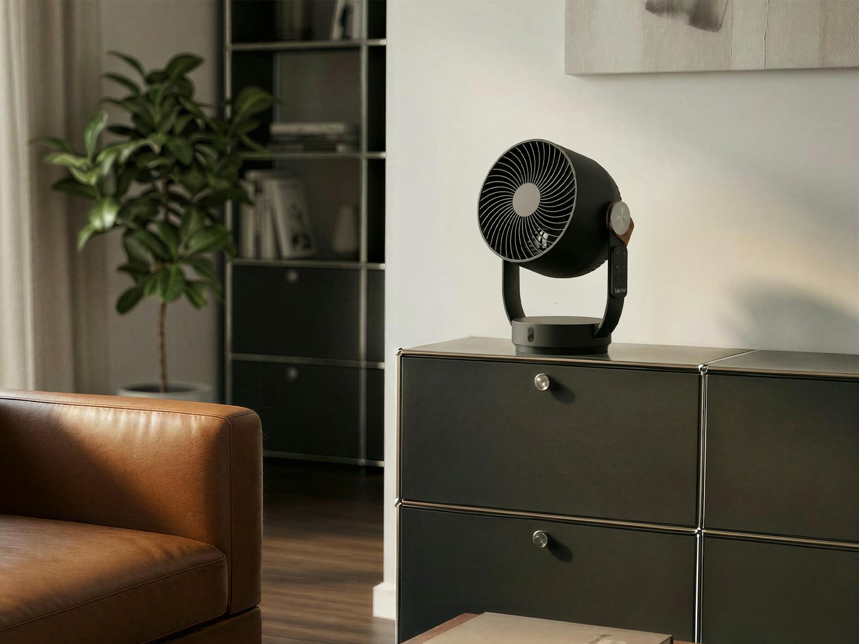 Stadler Form Leo fan in black, on a black sideboard