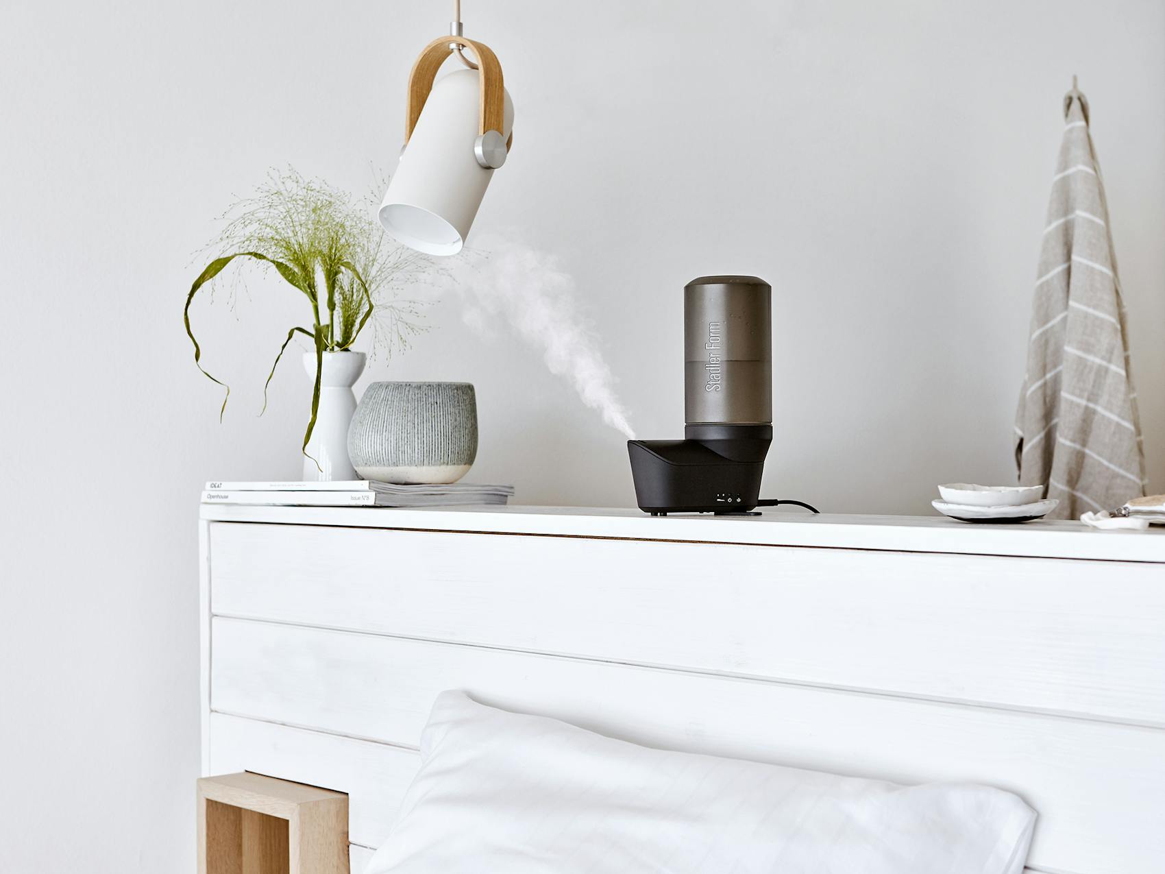Emma personal humidifier by Stadler Form in black on a sideboard