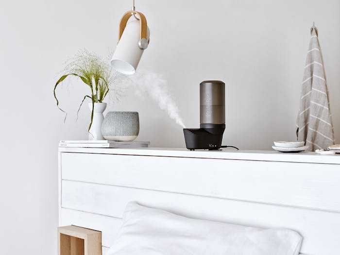 Emma personal humidifier by Stadler Form in black on a sideboard