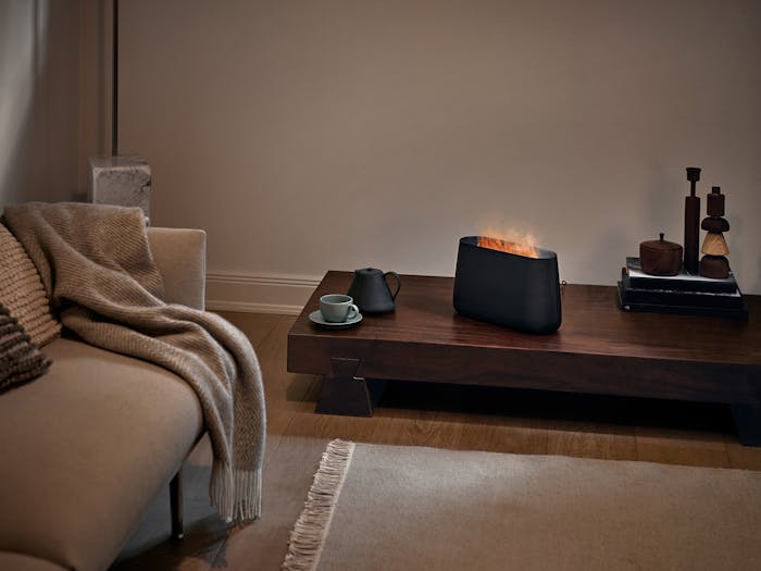 Ben humidifier by Stadler Form in black on a side table in a living room