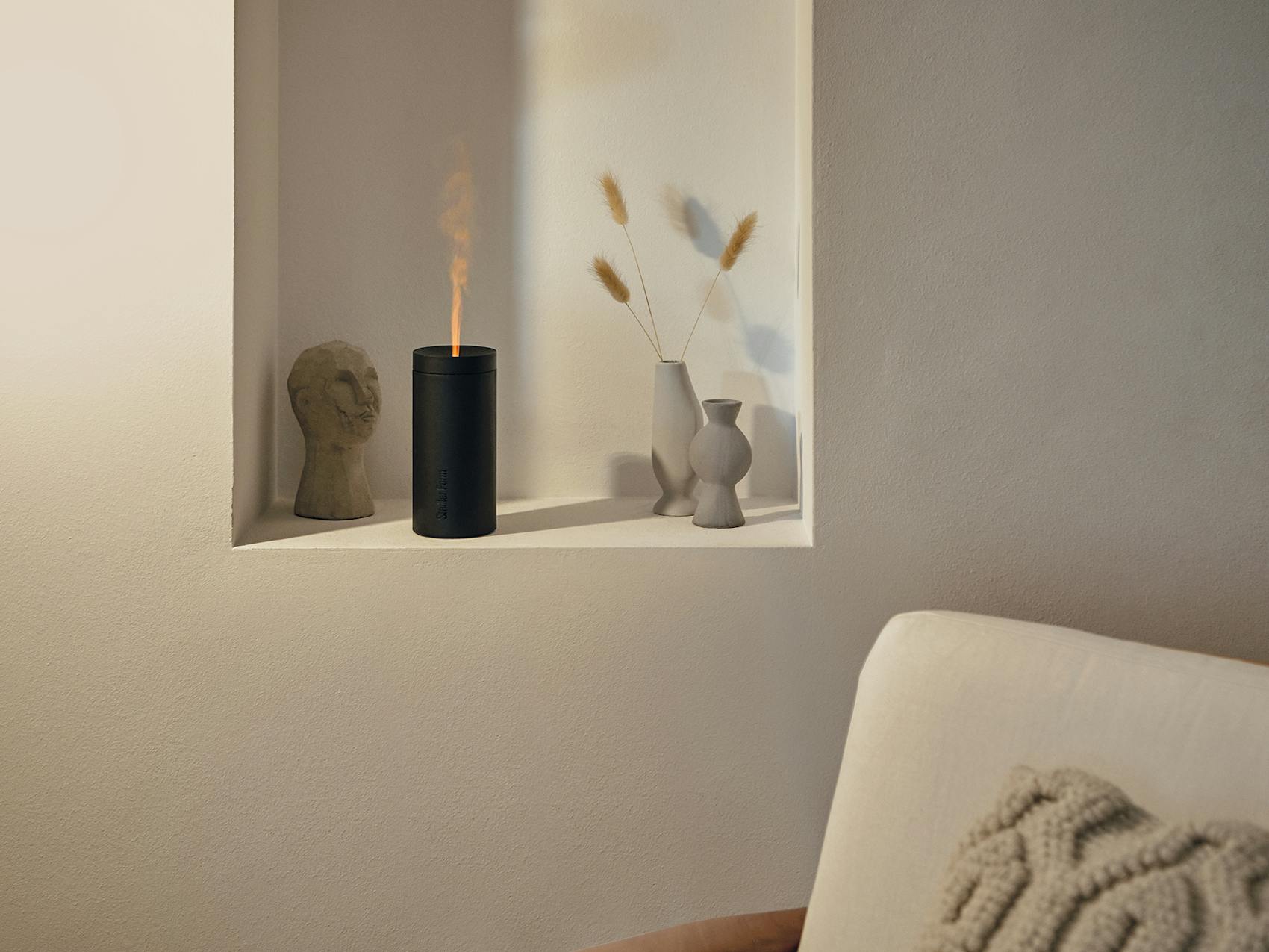 Lucy aroma diffuser by Stadler Form in black as decoration in a living room