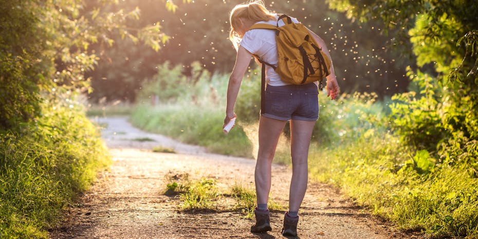 Woman with mosquito spray