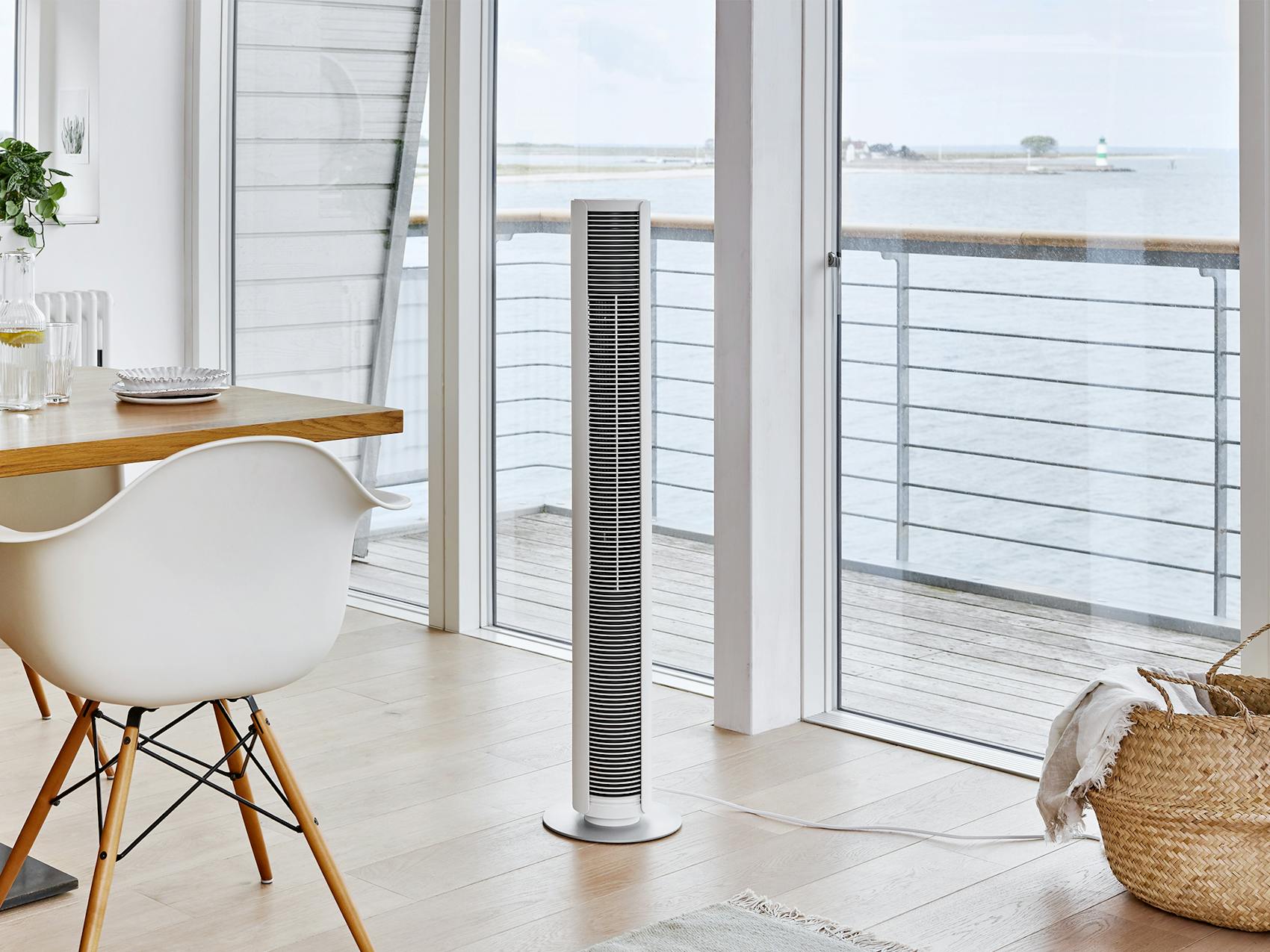 Peter tower fan by Stadler Form in white in a bright dining room