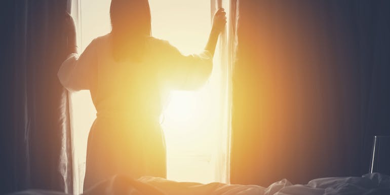 Woman at window with sunshine Woman at window with sunshine