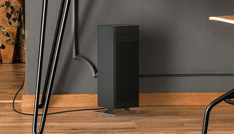 Anna big heater by Stadler Form in black below a desk