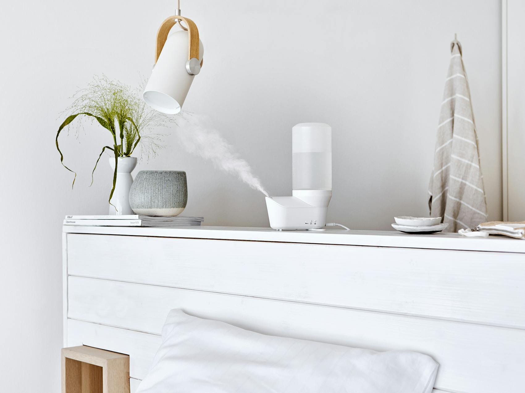Emma personal humidifier by Stadler Form in white on a sideboard
