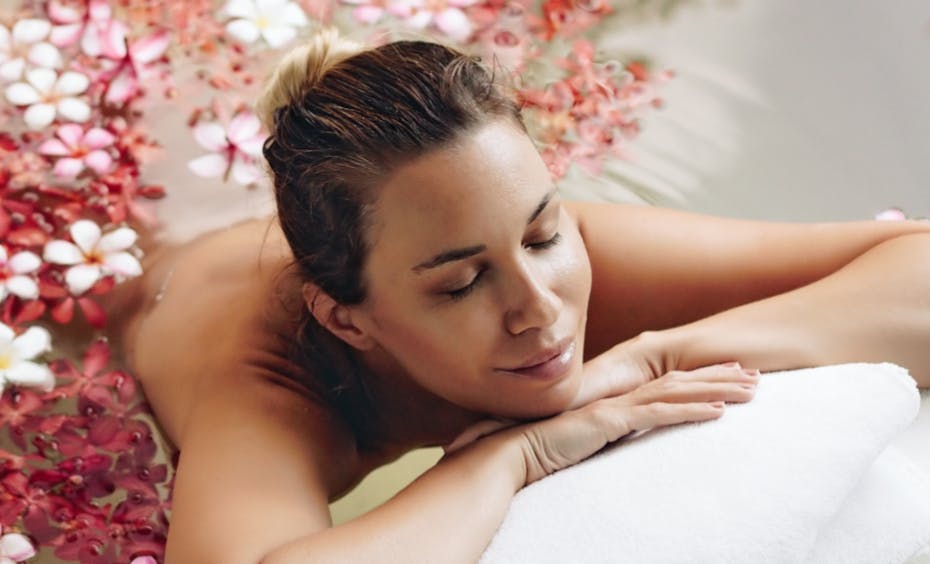 Stadler Form happy faces woman relaxing in a flower bath Stadler Form happy faces a woman relaxes during a wellness session in a flower bath