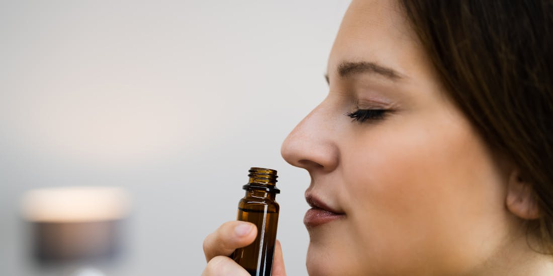 Woman inhales essential oil