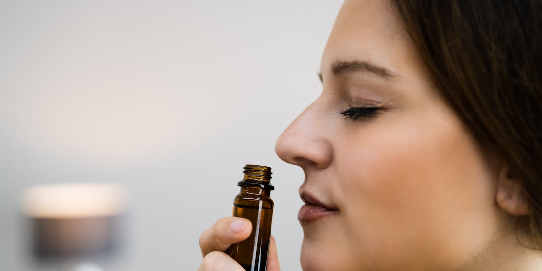 Woman inhales essential oil Woman inhales essential oil