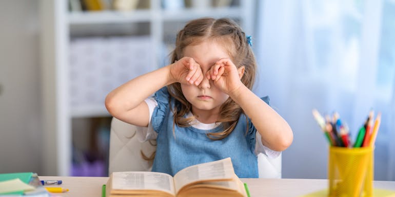 girl scratching eyes