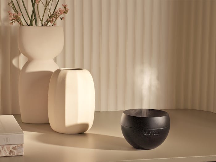 Jasmine mobile aroma diffuser in black on a sideboard