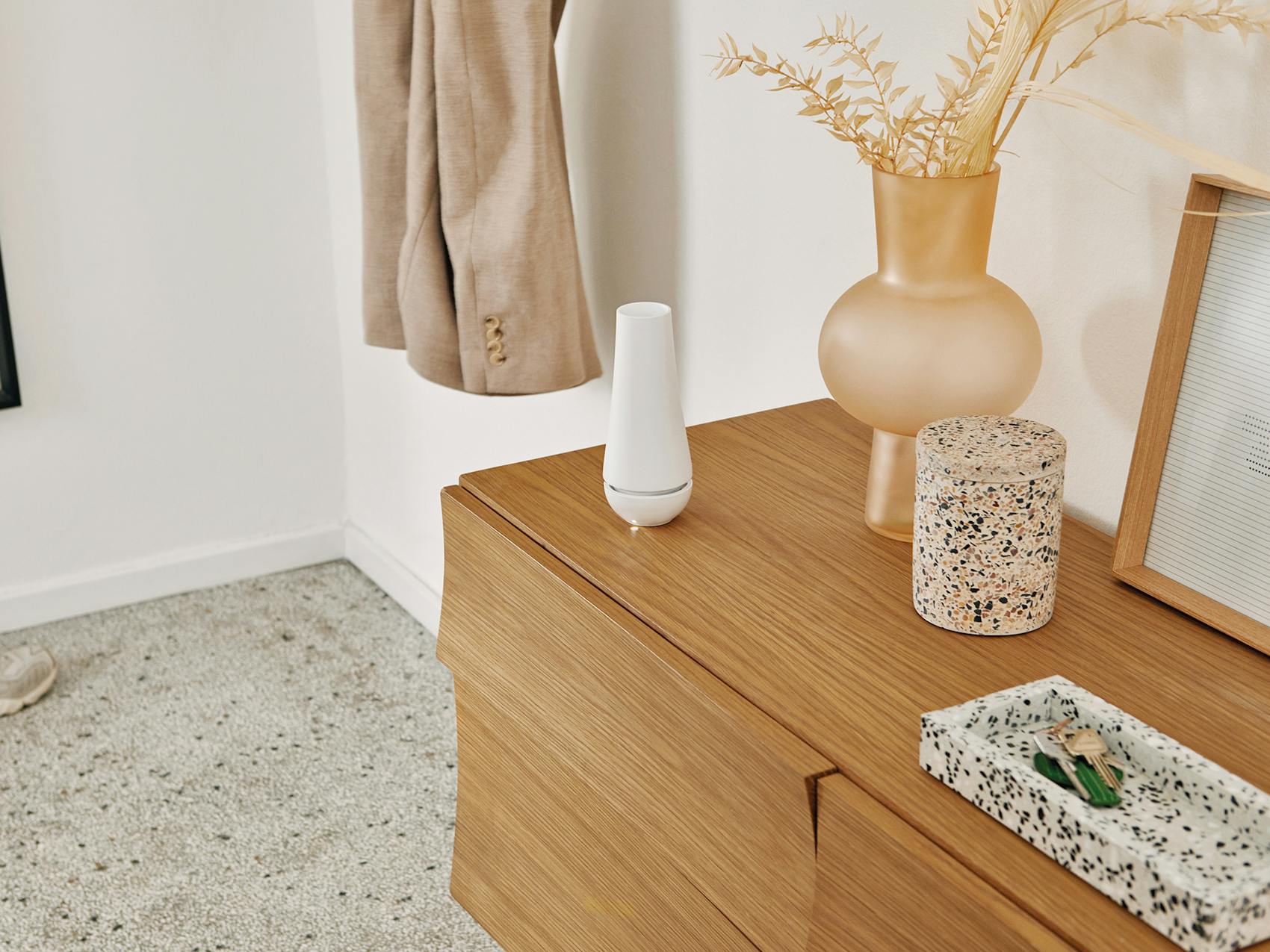 Tina aroma diffuser by Stadler Form on a sideboard in an entrance area