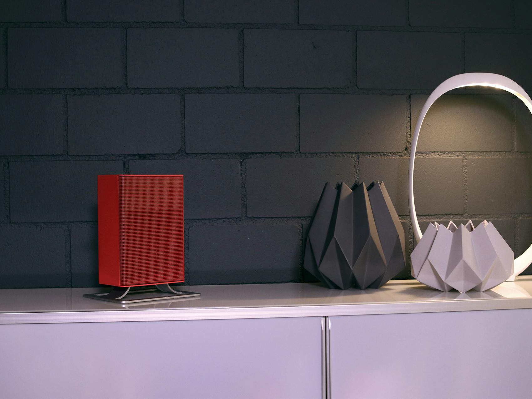 Anna little heater by Stadler Form in chili red on a sideboard