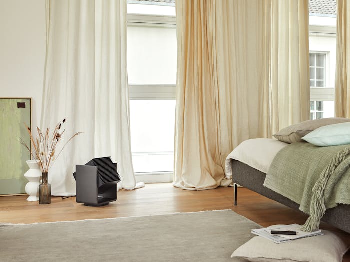 Alex heater by Stadler Form in black in a bed room