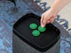 A hand places a fragrance pin Green Forest on Karl humidifier from Stadler Form