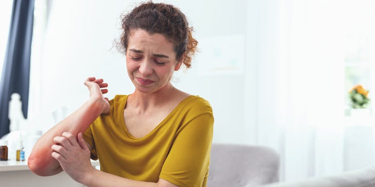 Woman with elbow pain Woman with elbow pain